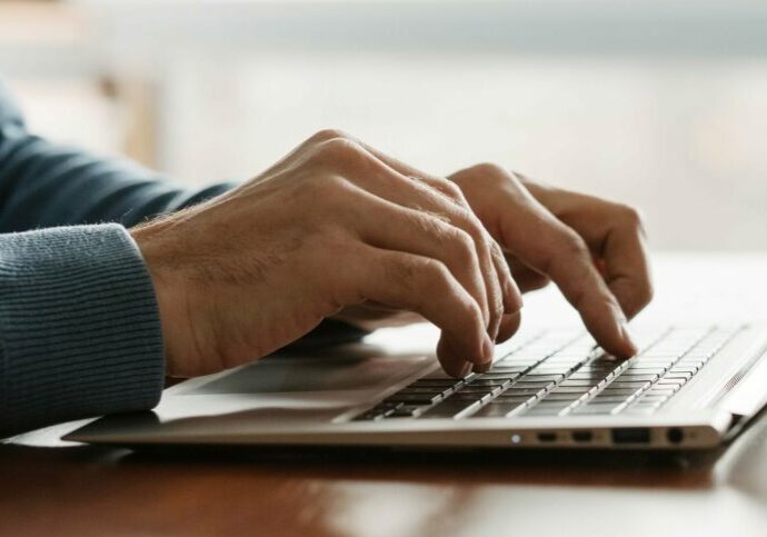 Man typing on Laptop