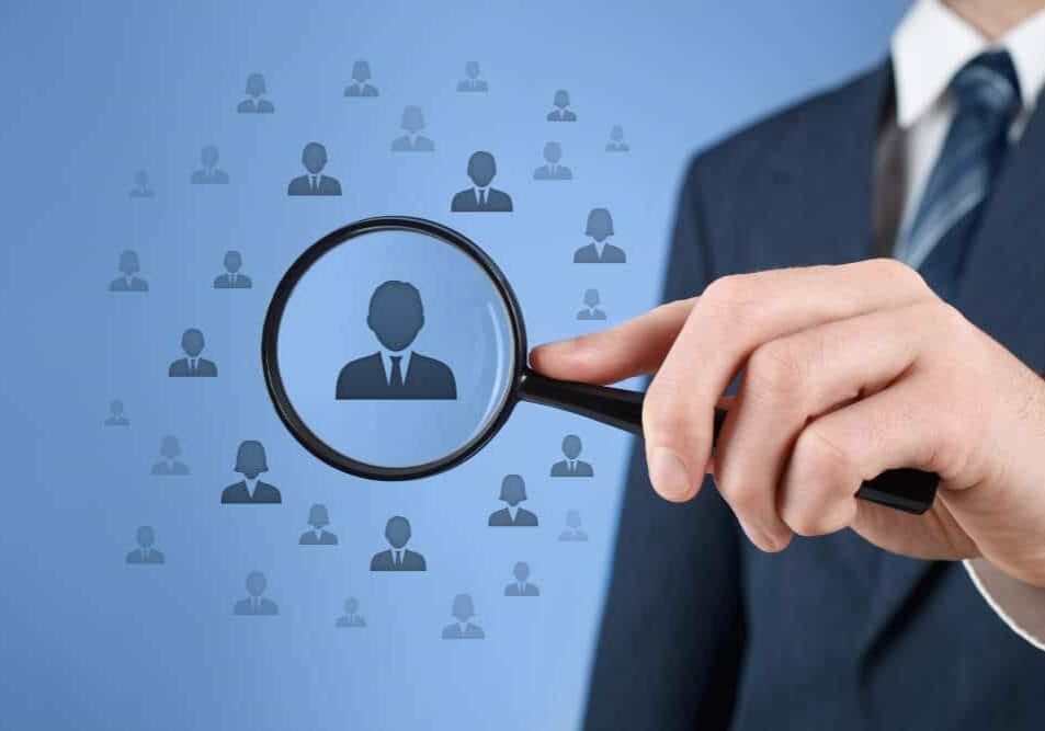 Employee singled out from crowd with magnifying glass