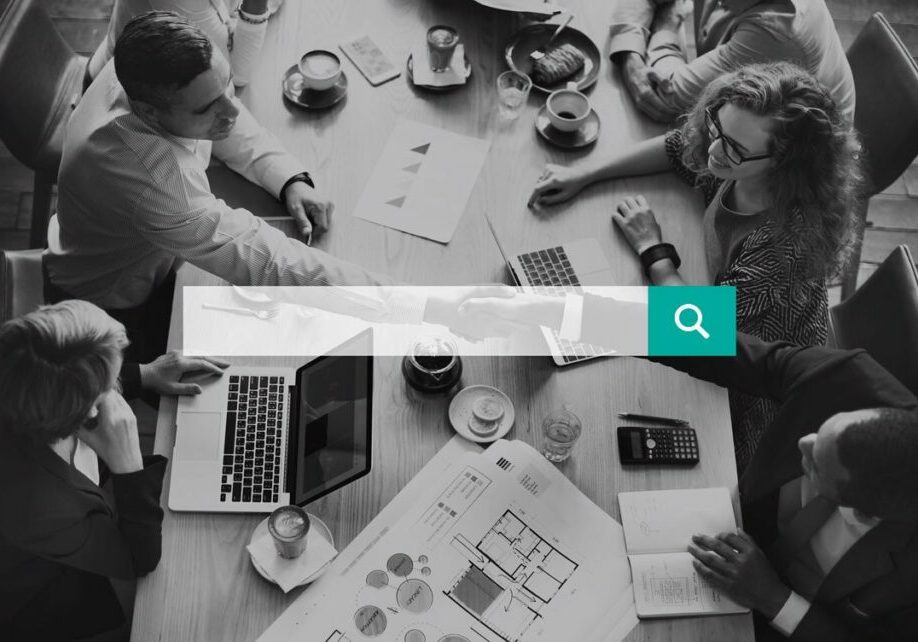 Business People shaking hands and using search engine