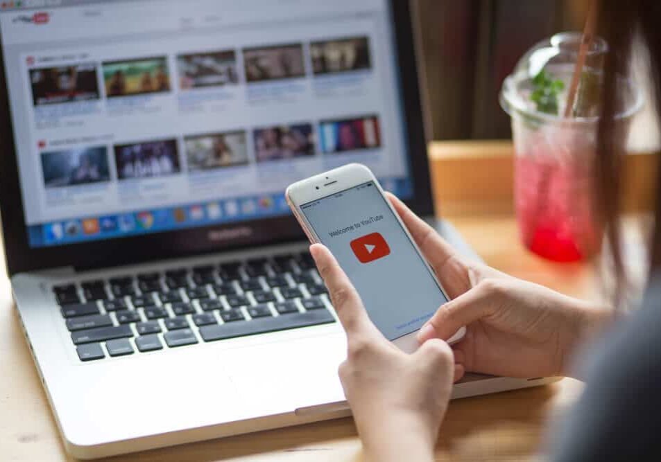 Youtube-Page-landscape-0e04e93f5a9c73aa527c2148376aa3ce-612558ba4edcc Woman using Youtube on Phone and Laptop