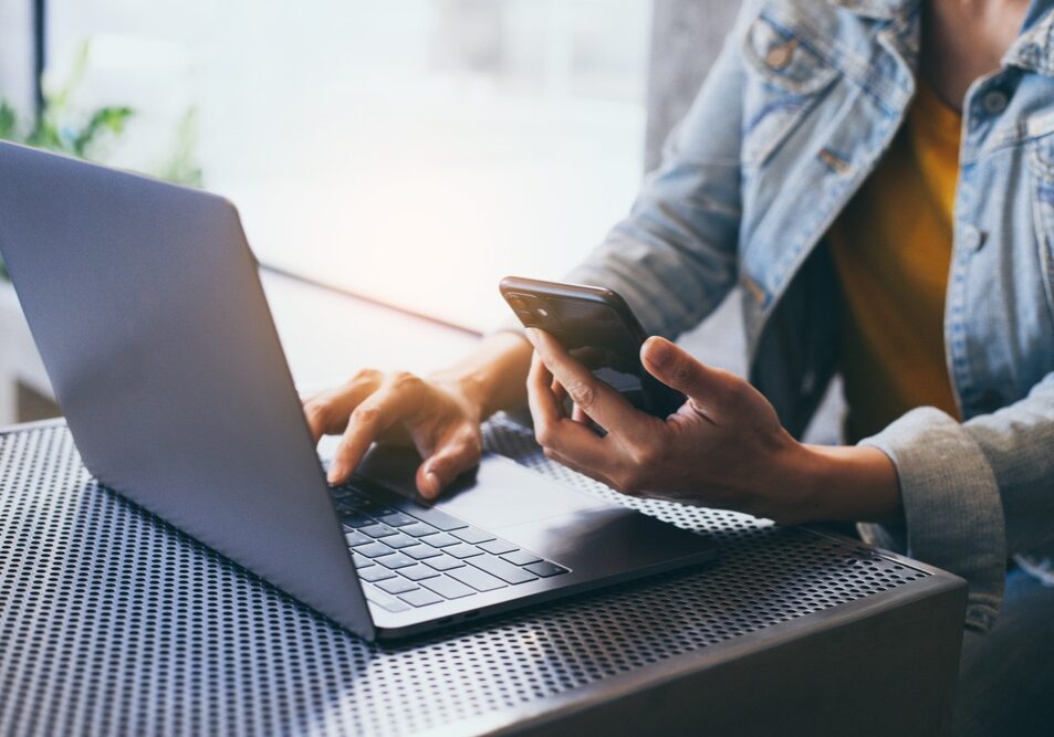 Man,Work,Using,Typing,Computer,Texting,Cell,Phone.student,Study,Education checking analytics using laptop and mobile