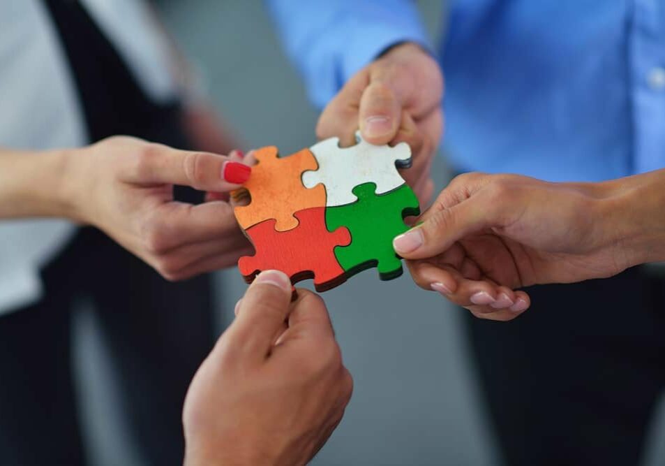 puzzle Team holding puzzle pieces together