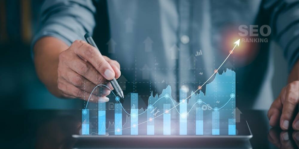 A marketer holds a pen pointing to a graph and shows SEO concepts