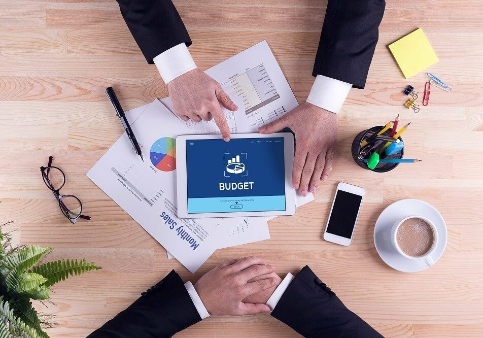 Business people using tablet for budgeting