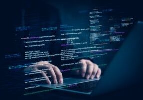 laptop with programming code on screen