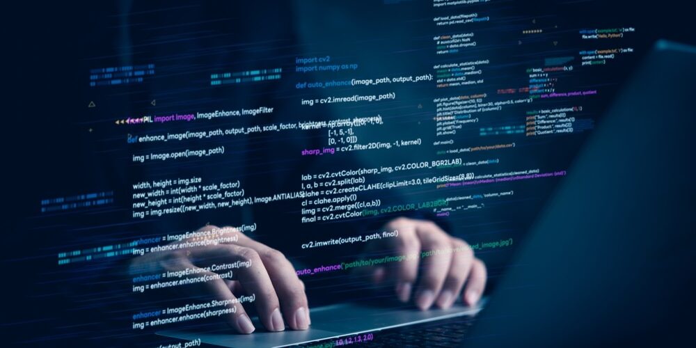 laptop with programming code on screen